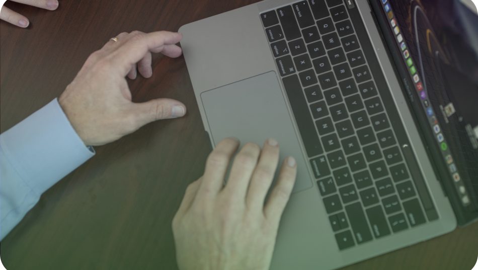 hands using a trackpad on a Macbook Pro